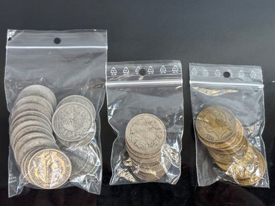 three bags of coins sitting on top of a table next to each other