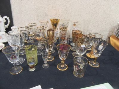 a lot of glasses on a table with a black table cloth