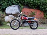 a red motorcycle parked on the side of the road