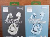 two boxes of clear sound earphones on a wooden surface