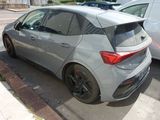 the rear end of a silver car parked on the side of the road