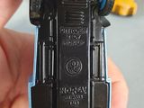 a toy car that is being held up in someone ' s hand