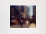a blurry photo of people walking down a city street