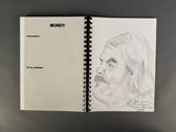 a drawing of a man ' s face is shown in a notebook