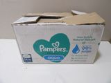 a box of diapers sitting on a table next to a bottle of water