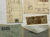 many old letters and envelopes on the wall