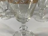 six wine glasses sitting on a table next to each other