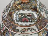 a large vase with a lid on a white surface