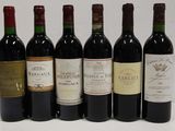 six bottles of wine are lined up in a row on a table