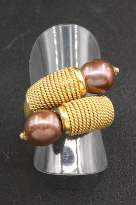 a silver ring with two brown beads on it