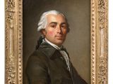 portrait of a man in a black coat and white hair