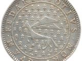 an old silver coin on a white background with a bird in the center