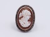 a close up of a ring with a cameo of a woman