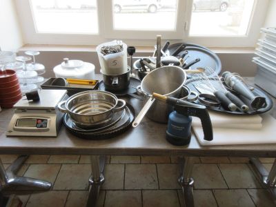 une table sur laquelle sont posés de nombreux ustensiles de cuisine