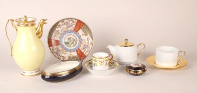 many different types of teapots and saucers on the table