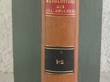 an old book sitting on top of a table next to a white wall