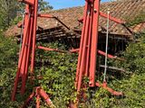two red poles in front of a building that has been torn down