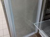 a refrigerator with a door open on a tiled floor