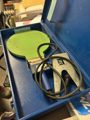 a blue box with a pair of pliers and a pair of pliers in it