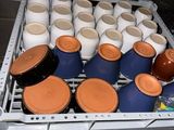many cups that are sitting on a rack in the kitchen