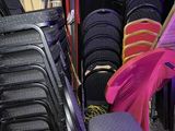 a lot of chairs that are stacked up in a room