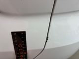 a measuring tape on the front of a white car