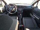 the interior of a small car with a steering wheel and dashboard