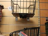 two baskets hanging on the wall of a store