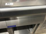 an image of a stainless steel counter top with a toaster on it