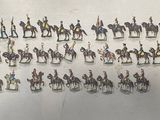 a lot of figurines of people riding horses on a wall