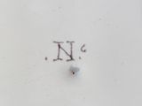 a close up of a plate with the letter n on it