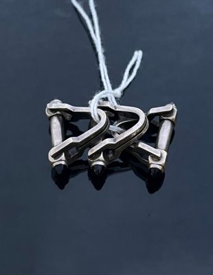 a silver ornament hanging from a string