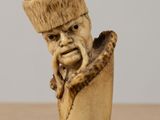 a figurine of a man with a hat on his head