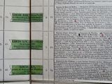 an old book with a bunch of green labels on it