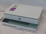 a white printer sitting on top of a white table