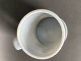 a white cup that is sitting on a table