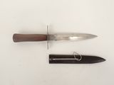 a knife and a knife holder on a white surface