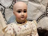 a doll with a bald head sitting on a table