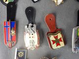 a lot of different types of badges on a table