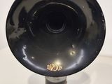 a black hornphone sitting on top of a white table