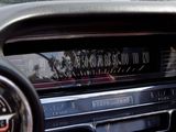 a close up of a car ' s dashboard with a clock