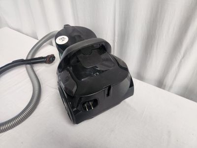 a black blow dryer sitting on top of a white table