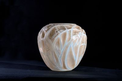 a vase that is sitting on a black surface