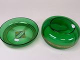 pair of green glass bowls and a green glass bowl on a white surface