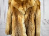 a close up of a fur coat on a mannequin stand