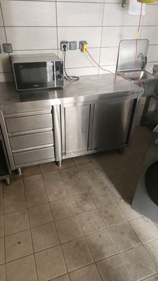 a kitchen with a microwave and a washer and dryer