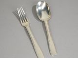 two spoons and a fork on a table
