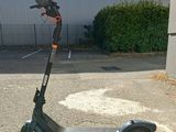 an electric scooter parked in a parking lot next to a building