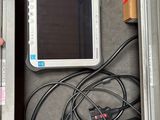 a tablet computer sitting in a metal box with wires