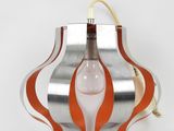 an orange and silver lamp with a light bulb attached to it